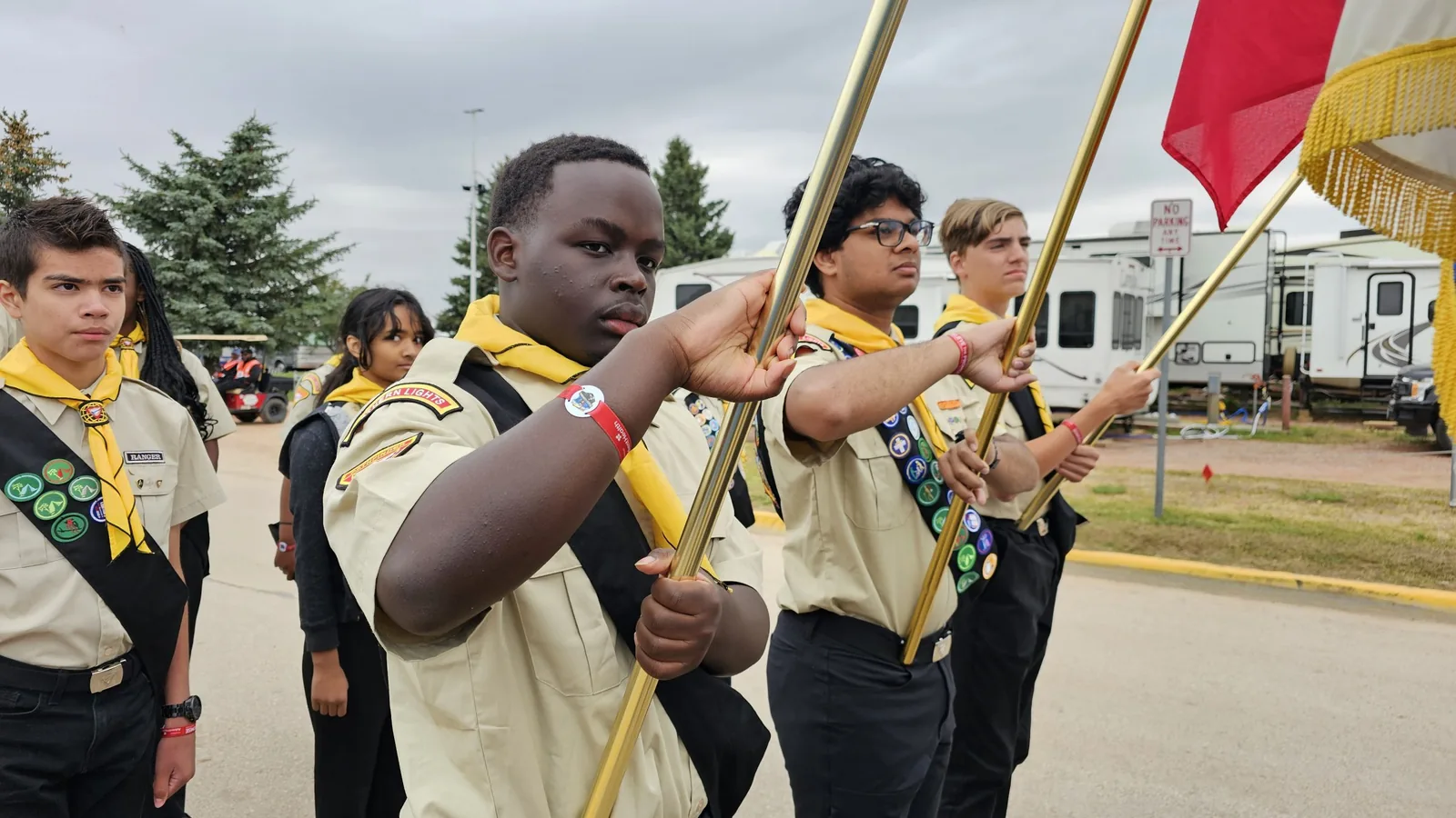 Northern Lights Pathfinders raising flags during the opening ceremony of a camporee