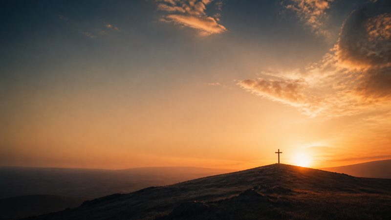 Why the Cross? &mdash; a small wooden cross on a hilltop at dawn