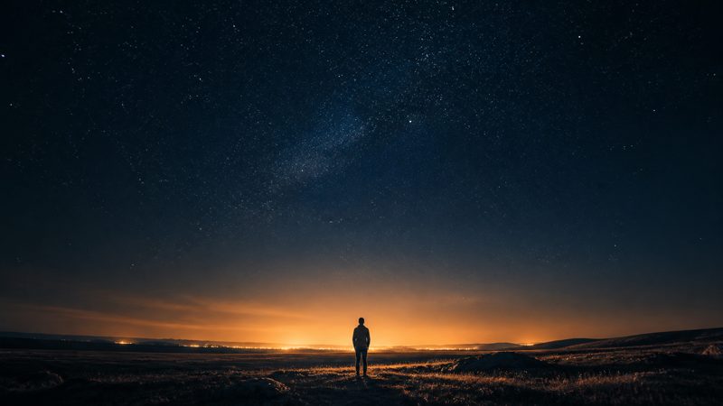 Why Me? &mdash; a lone figure under a vast starry sky