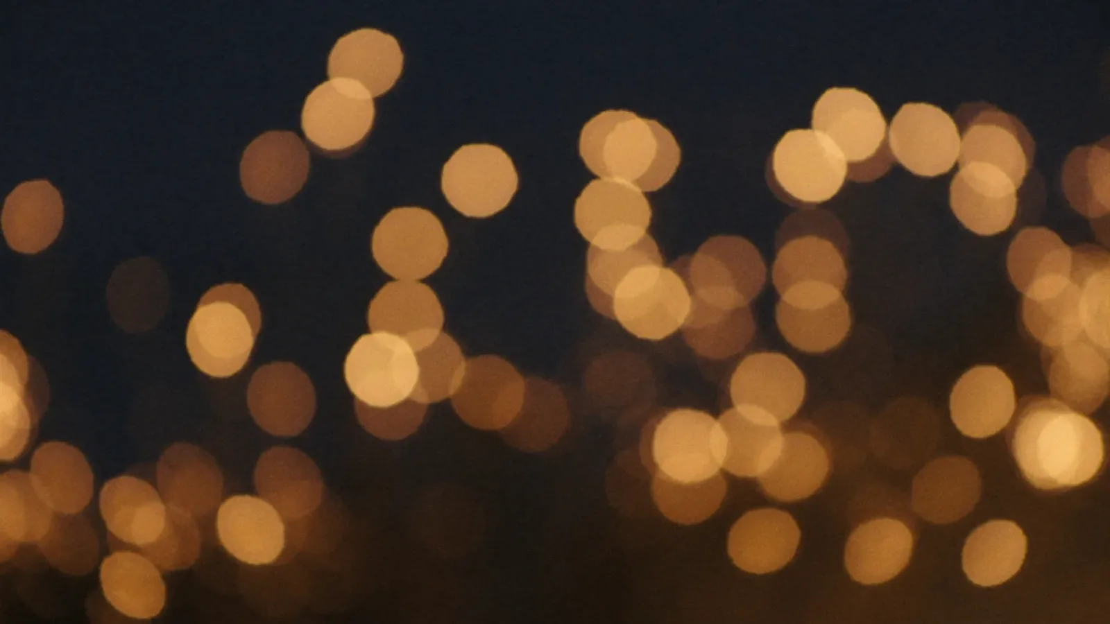 Warm candlelight glowing softly in a gathering space