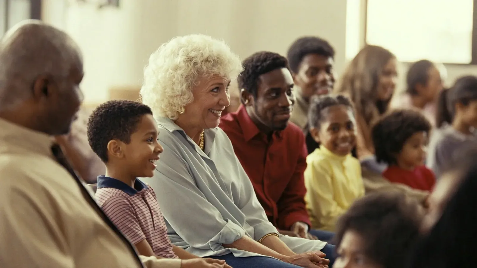A congregation of children, parents and grandparents seated together in worship
