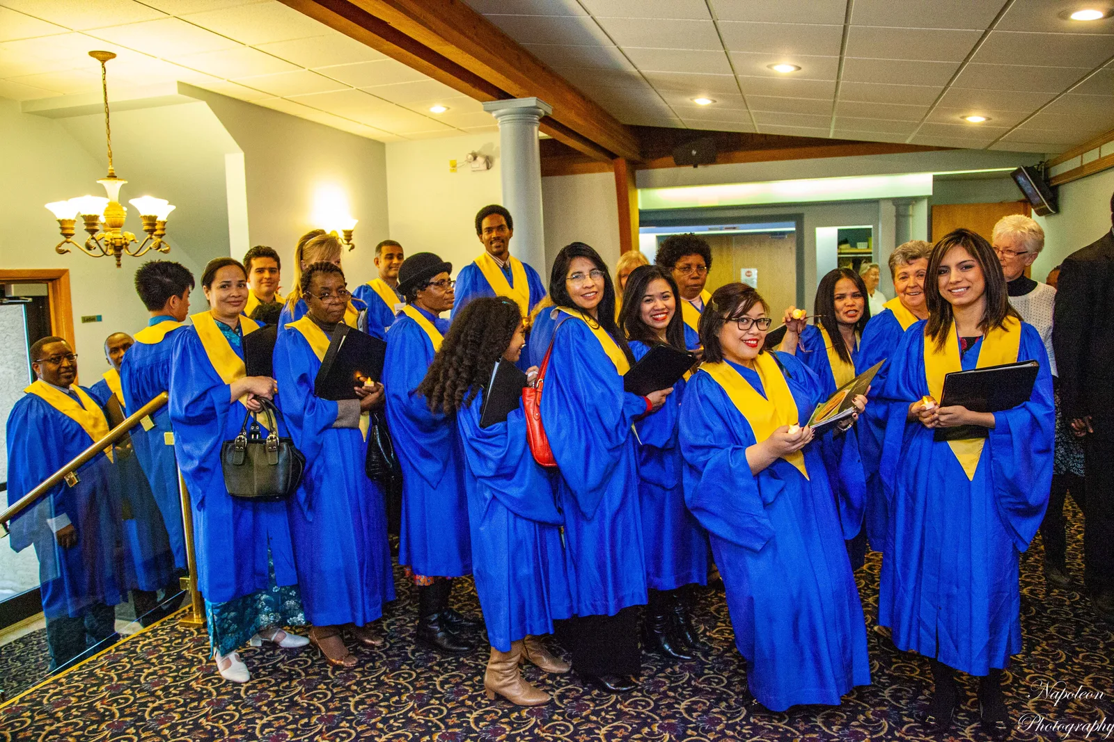 Edmonton Central choir members in blue and gold robes gathered in the church foyer before a Christmas programme