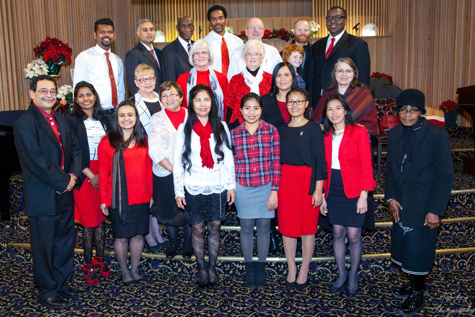 Edmonton Central choir members in red and black standing together at a Christmas service