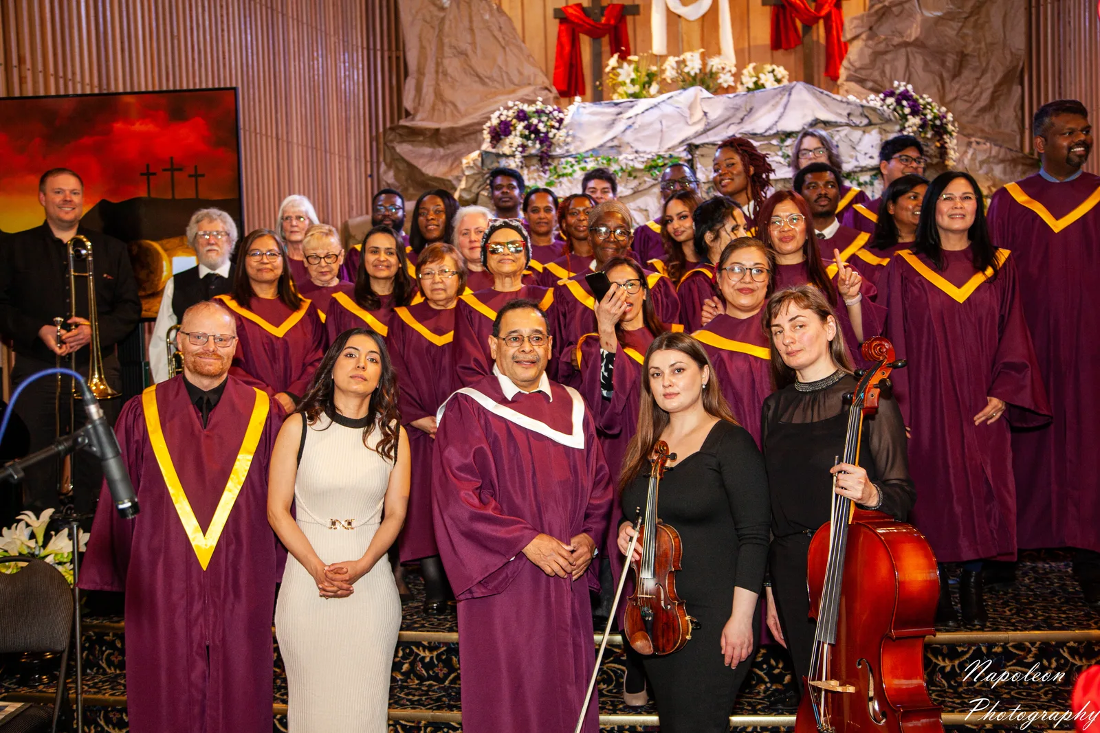 The Edmonton Central choir in maroon and gold robes with a violinist and cellist at the Easter service