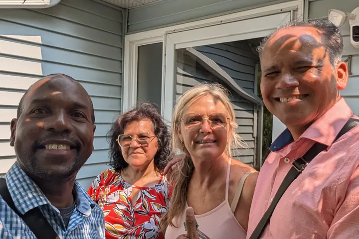 Edmonton Central Personal Ministries team members meeting a resident at her front door