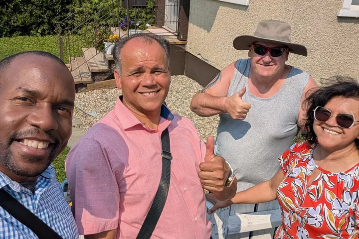 Personal Ministries team members with a community member in his garden during a visit